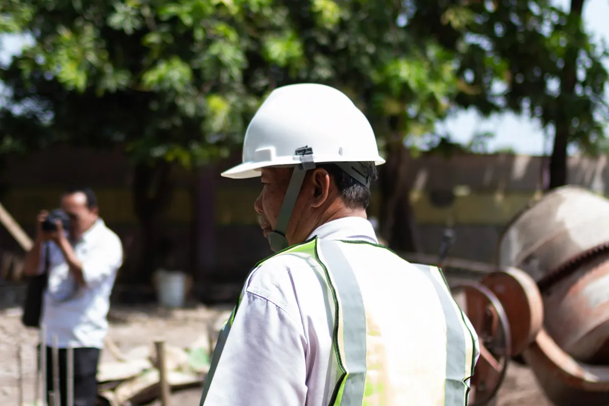 An engineer in a hard hat and safety vest on site